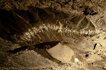 A detailed view of textured cave walls with natural rock formations and mineral patterns