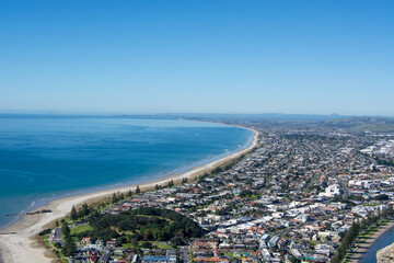 Aerial View of Coastal City with Sandy Beach and Clear Water