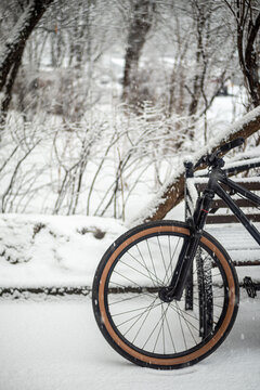 Extreme Bicycle in Fresh Winter Snow Near Bench