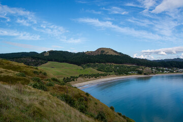 Serene Coastal Landscape with Calm Bay and Green Hills