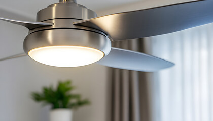 Contemporary brushed nickel ceiling fan with integrated LED light shown isolated on a white stand