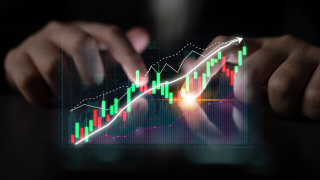 Close-up view of hands manipulating digital financial graphs, showcasing stock market trends with ascending lines, emphasizing success and analytical insight. Impute