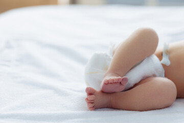 Close-up of newborn baby feet on bed