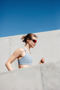 Athlete runs on urban pathway