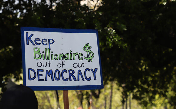 Signs from HANDS OFF protest
