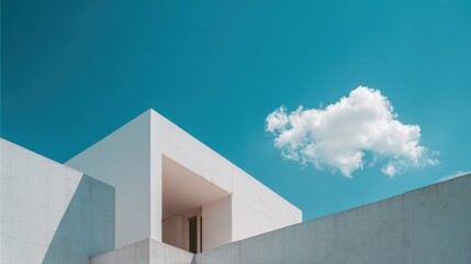 Modern Minimalist Architecture with Clean Lines and White Facade Under a Bright Blue Sky with a Cloud