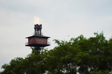 torch tower with a combustion gas outlet in a steel mill.