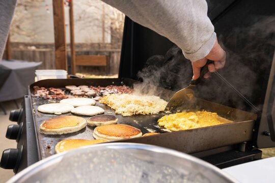 Grilling Pancakes and Eggs for Outdoor Breakfast
