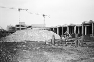 Construction Site With Cranes and Earth Movers in Urban Area