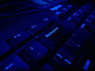 Close-up of a modern computer keyboard with sleek keys, ideal for illustrating digital workspaces,...