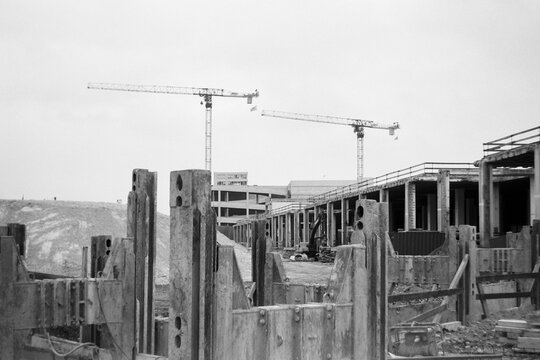 Construction Field Operate Cranes Above a Developing Site
