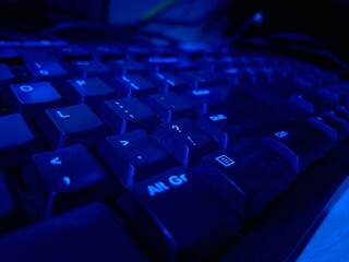 Close-up of a modern computer keyboard with sleek keys, ideal for illustrating digital workspaces,...