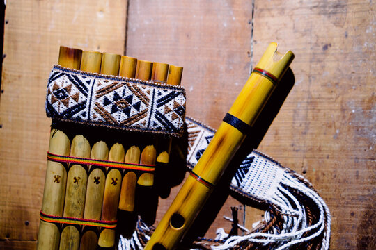 Andean flute and panpipe, traditional musical instruments of the Andes on wood with a black background