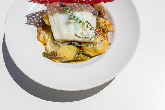 a dish of hake with vegetables and pretty decoration