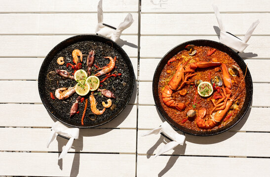 two paellas of different preparations on a table