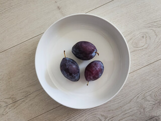 Sugar plums fruits in a white bowl