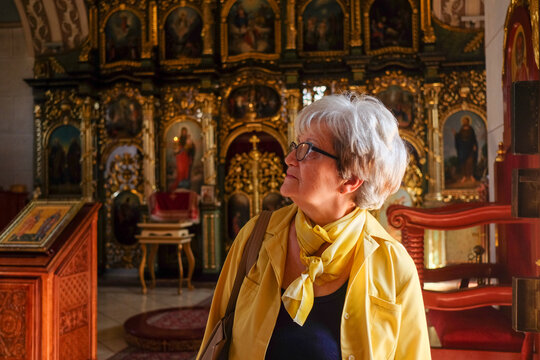 Woman Reflecting Inside Ornate Church
