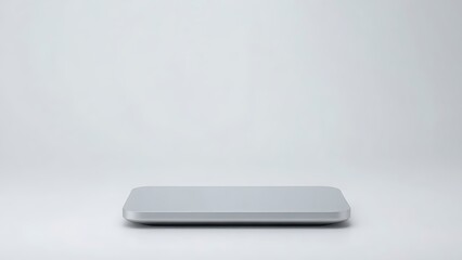 Sleek rectangular device with glossy finish on a gradient backdrop, exemplifying minimalist technological aesthetics.