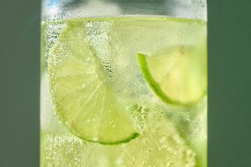 A close-up shot of a refreshing cocktail with lime slices submerged