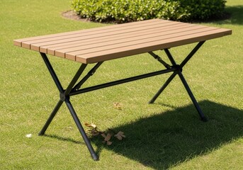 Wooden slatted folding table with black metal legs on a grassy lawn