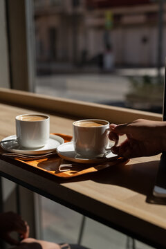 Woman taking cup of coffee