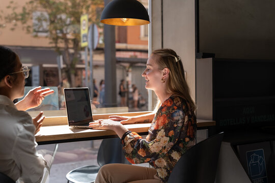 Colleagues meeting at coffee shop - Powered by Adobe