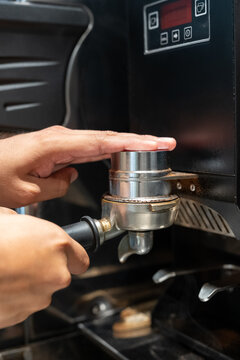 Barista filling portafilter at coffee shop