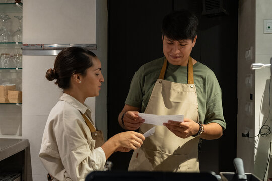 Cafe owners reading letter from tax office