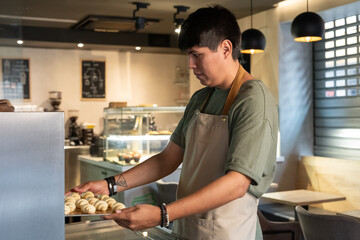 Baker Preparing Freshly Made Pastries in a Cozy Cafe