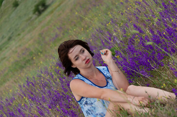 Photo session outdoors of a pretty girl in shorts, a shirt and a dress