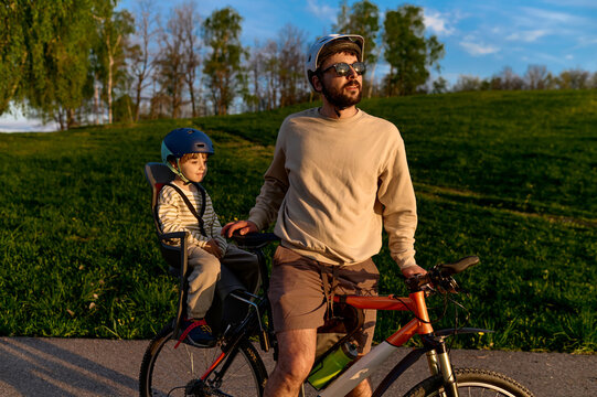 A father and child pause their bike ride in nature