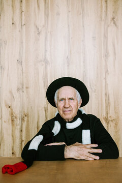 Man in scarf and hat smiling