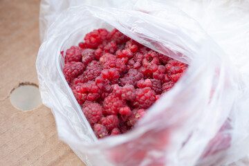 Bag full of red raspberries