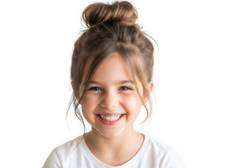 Happy young girl with messy bun hairstyle smiling against black background