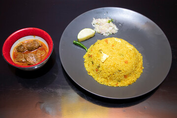 Bhuna Khichuri with Beef Rezala and Salad side view of Traditional Bengali Festive Rice