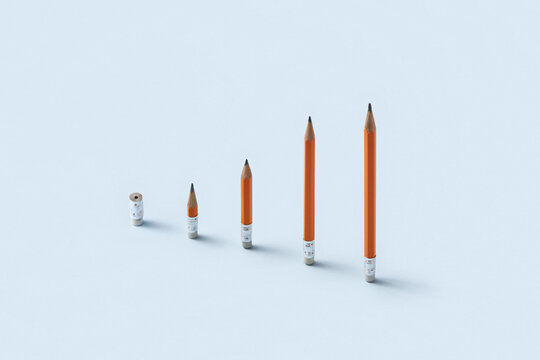 Bar chart made of sharpened orange pencils on blue