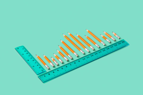 Bar chart made of pencils and rulers, top view
