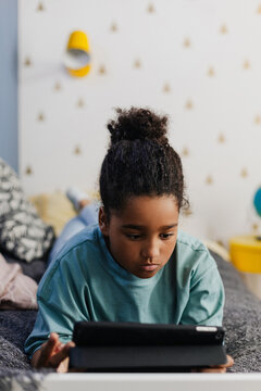 African girl struggling with slow internet connection on tablet 