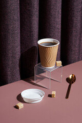 Coffee concept, takeaway cup of black coffee with sugar cubes as the hero.