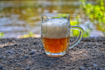 Smoked, white beer with foam on the shore