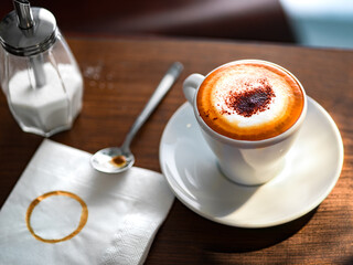 cup of cappuccino served on a rustic wooden table