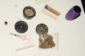 marijuana buds in bag and rolling tools