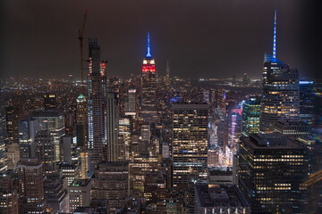 Fototapeta premium View to the New York City downtown of Manhattan during night life and with the Empire State Building at the background