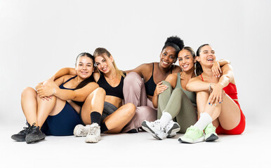 A group of girls between the ages of 20 and 30 from various ethnic backgrounds are posing on a...