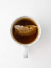 Herbal tea sachet in cup, hot water with chamomile and Hypericum or St. John's wort teabag