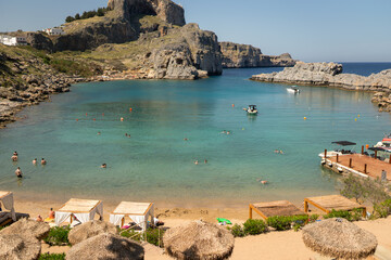 Calm Bay with Bathers and Wooden Cabanas