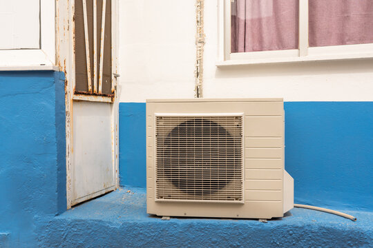 Air Conditioner by Rusty Door and Window