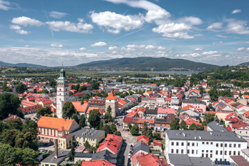 Picturesque historic center and panoramic aerial views of Żywiec, Poland—a charming town by the Beskid mountains and Żywiec Lake. Old town, cathedral tower and a scenic landscape on a summer day.