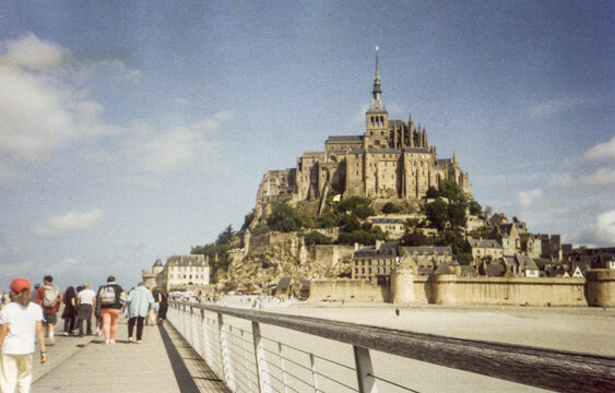35mm film view of tourists walking to Mont Saint-Michel, Normandy