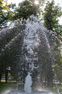 Water splashes from a water fountain in the sun